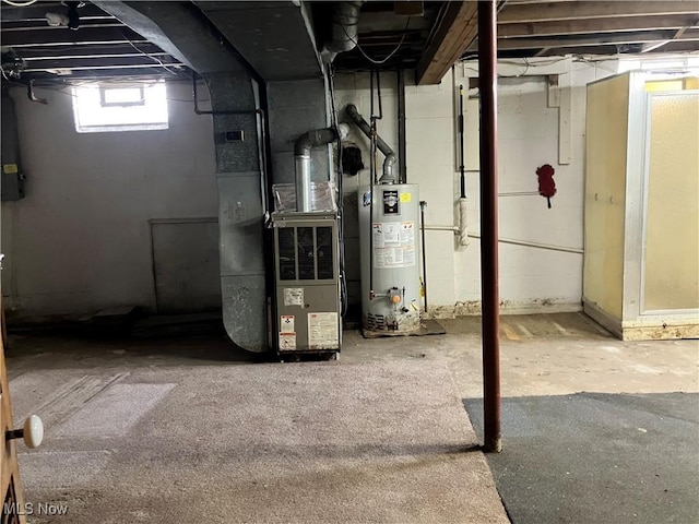 below grade area featuring water heater and heating unit