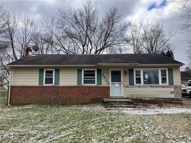 view of front of property with brick siding and a chimney