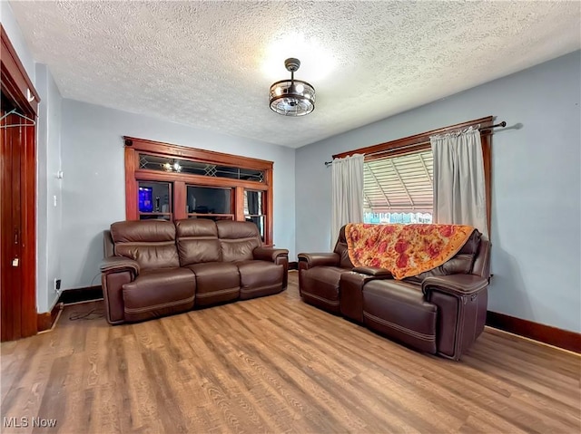 328 Scott Ave, Niles, OH 44446 - living area with wood finished floors, baseboards, and a textured ceiling