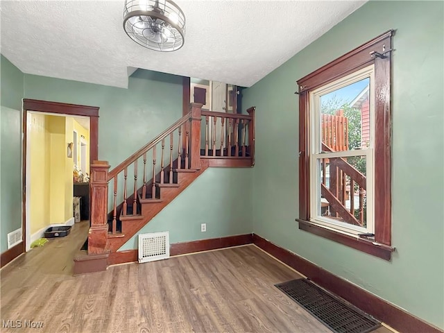328 Scott Ave, Niles, OH 44446 - stairway featuring wood finished floors, baseboards, and a textured ceiling