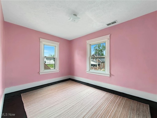 328 Scott Ave, Niles, OH 44446 - spare room with a textured ceiling and baseboards