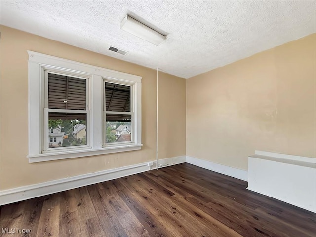 328 Scott Ave, Niles, OH 44446 - unfurnished room featuring dark wood finished floors, a textured ceiling, and baseboards