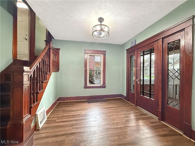 328 Scott Ave, Niles, OH 44446 - entryway featuring plenty of natural light, wood finished floors, a textured ceiling, stairway, and baseboards