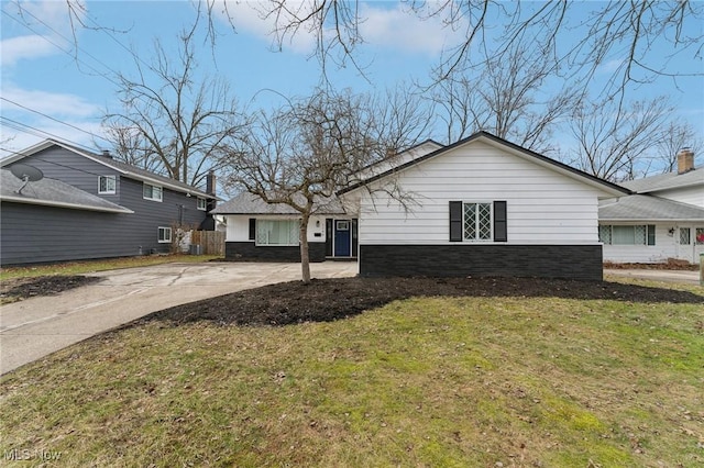 exterior space featuring driveway and a yard