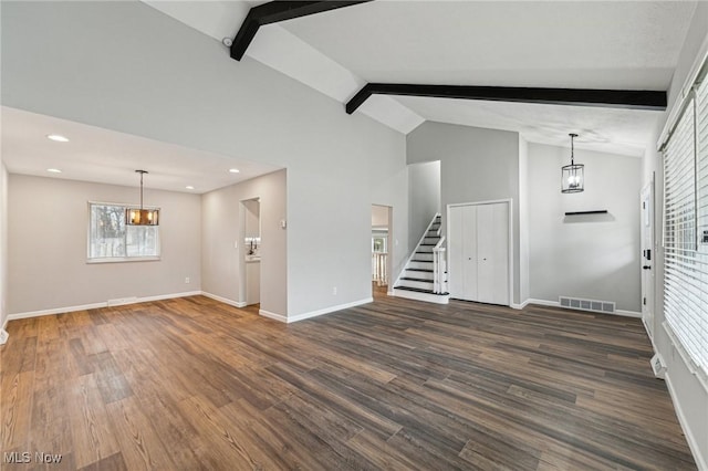 unfurnished living room with dark wood-style flooring, visible vents, beamed ceiling, and stairway