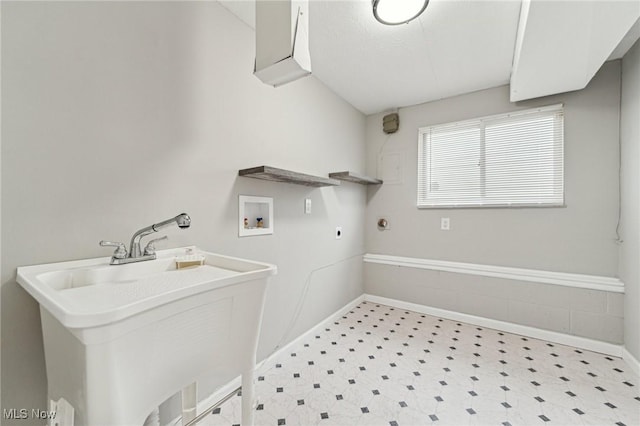 laundry room with laundry area, tile patterned floors, hookup for a washing machine, hookup for an electric dryer, and a sink