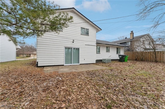 rear view of property with central air condition unit, a patio area, and fence