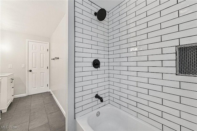 full bath featuring shower / tub combination, tile patterned flooring, vanity, and baseboards