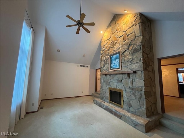 unfurnished living room featuring visible vents, a ceiling fan, carpet flooring, a stone fireplace, and high vaulted ceiling