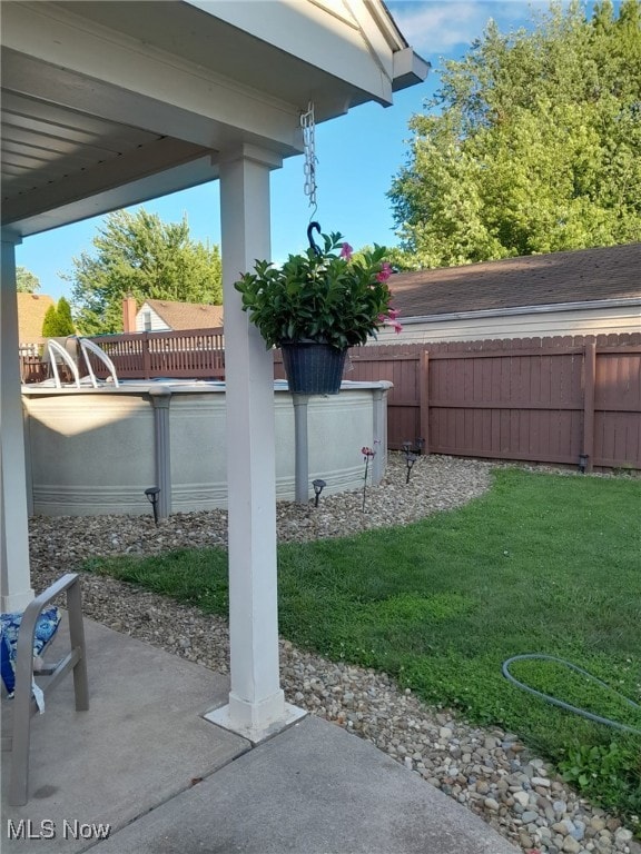 view of yard with fence and a patio