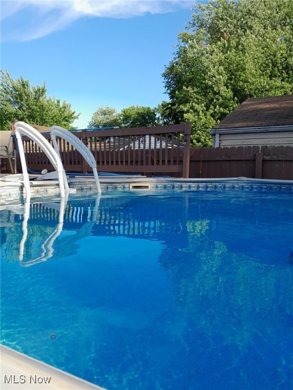 view of pool with a fenced in pool and fence