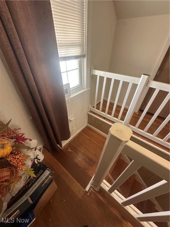 staircase featuring wood finished floors