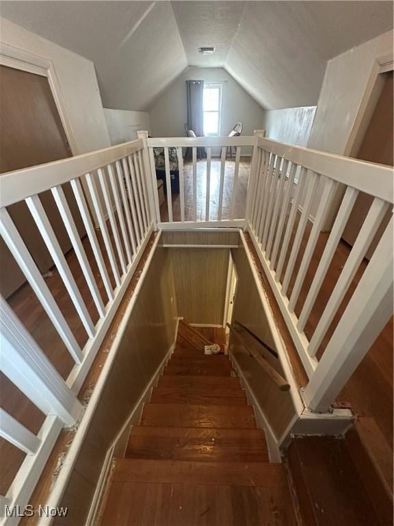 stairs with vaulted ceiling