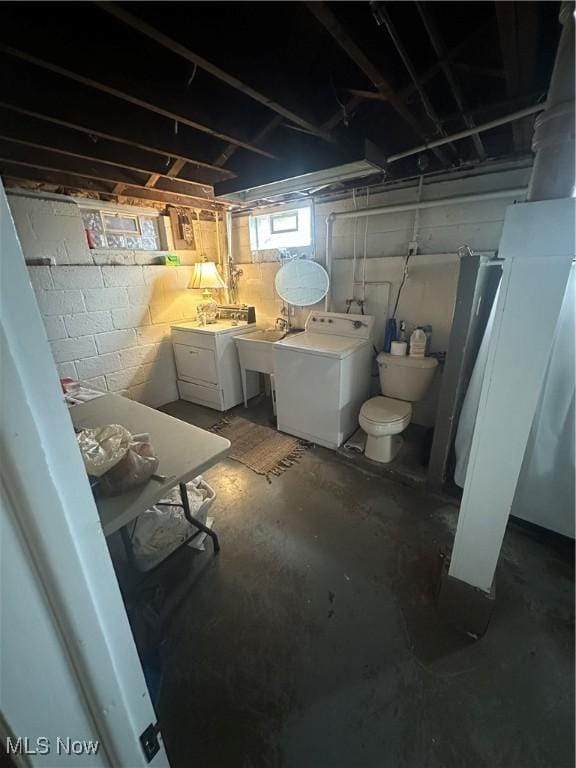 below grade area featuring washer and dryer and a sink