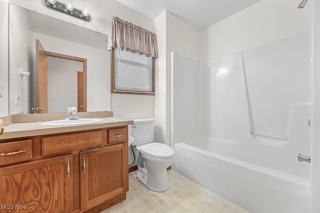 full bathroom featuring toilet, tub / shower combination, vanity, and tile patterned floors