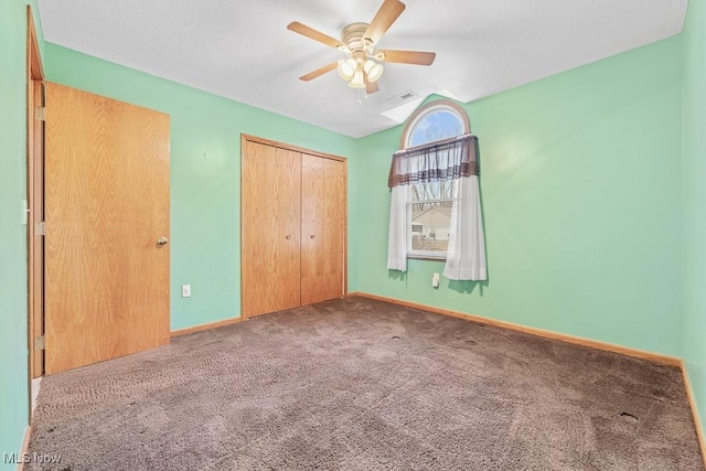 unfurnished bedroom featuring a closet, carpet, visible vents, and baseboards