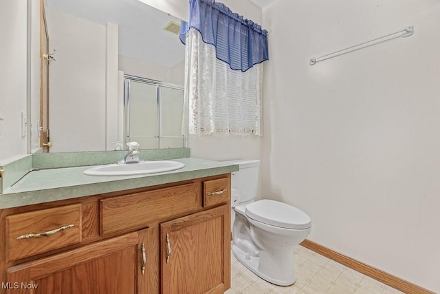 full bathroom with toilet, vanity, baseboards, a shower stall, and tile patterned floors