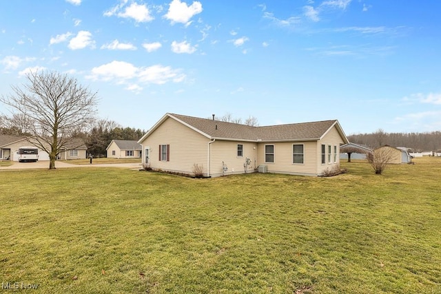 rear view of house with a lawn