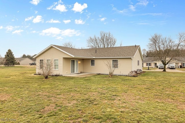 back of house featuring a patio area and a lawn