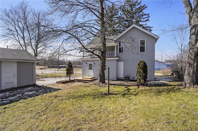 view of property exterior with an outbuilding, a yard, and central air condition unit