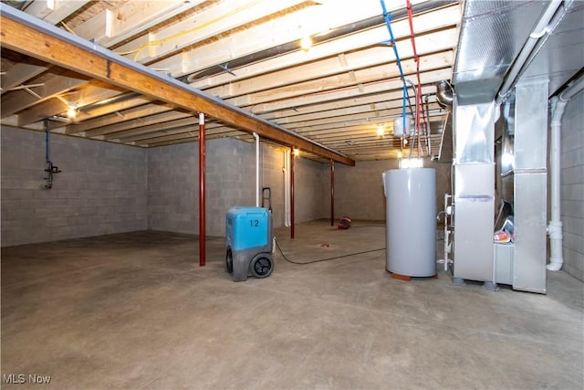 unfinished basement with water heater and heating unit