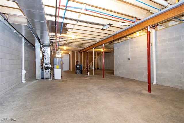 unfinished below grade area featuring electric water heater and heating unit