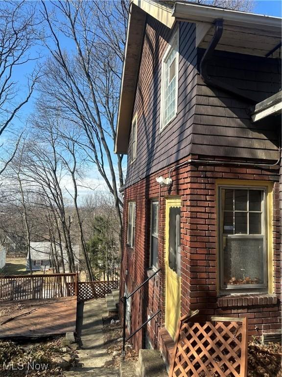 view of property exterior with brick siding