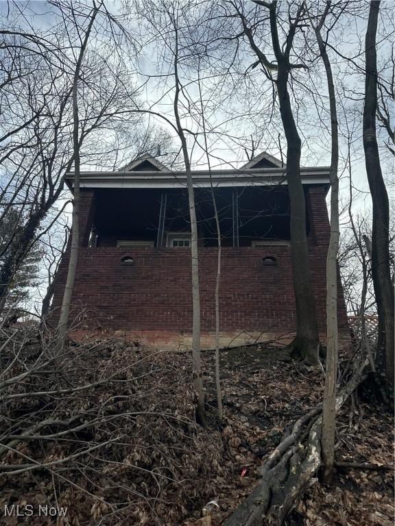 view of property exterior featuring brick siding