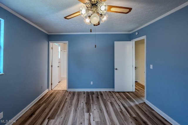 unfurnished bedroom featuring ornamental molding, a textured ceiling, and wood finished floors