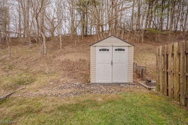 view of shed featuring fence