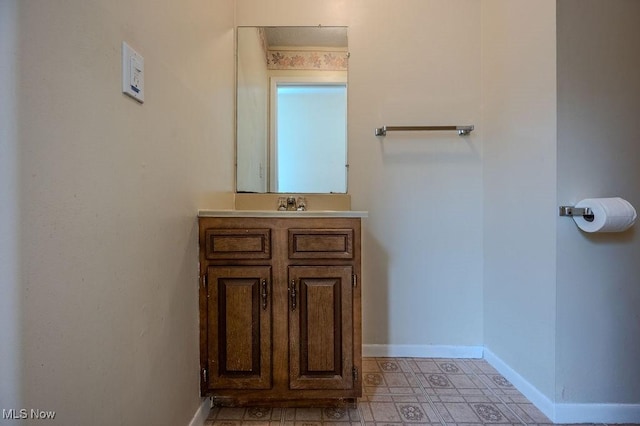 bathroom featuring baseboards and vanity