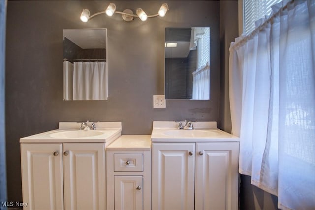 bathroom featuring double vanity and a sink