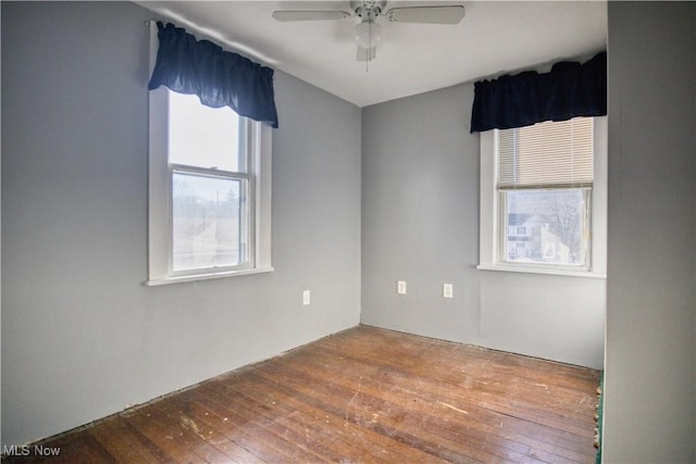 empty room featuring wood-type flooring and ceiling fan