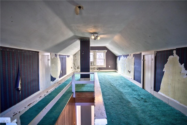 bonus room featuring lofted ceiling and carpet flooring