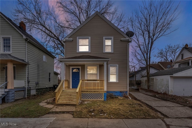 traditional-style home with a porch and an outbuilding