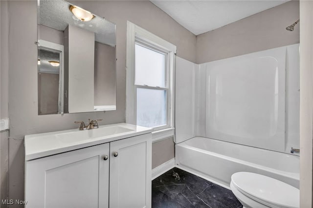 full bath with shower / bathtub combination, toilet, vanity, baseboards, and marble finish floor