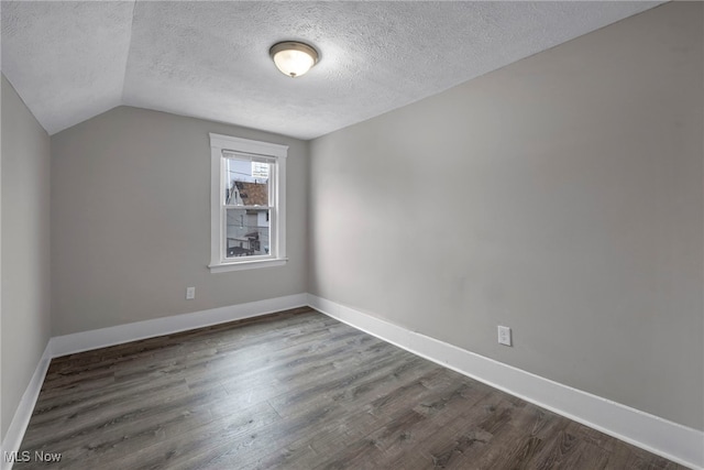 bonus room featuring lofted ceiling, dark wood-style flooring, and baseboards