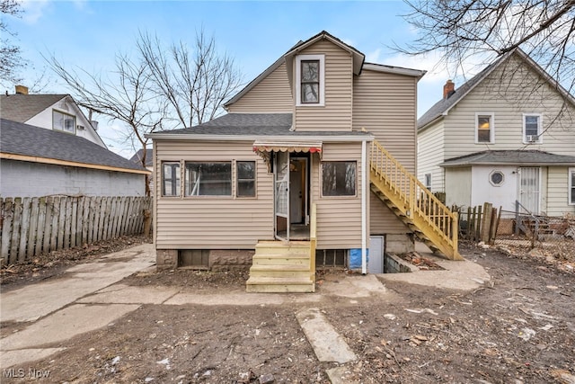 rear view of property with fence