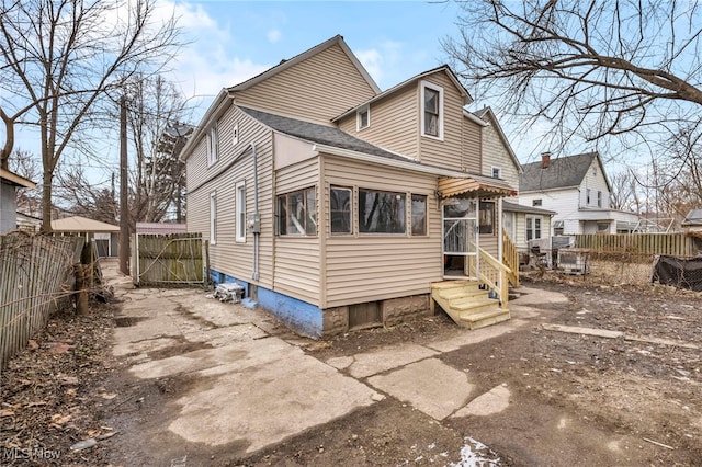 back of house with fence