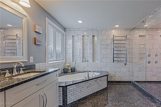 full bathroom featuring a garden tub, recessed lighting, a tile shower, and vanity