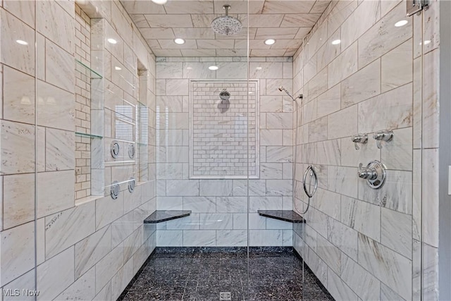 bathroom with a tile shower