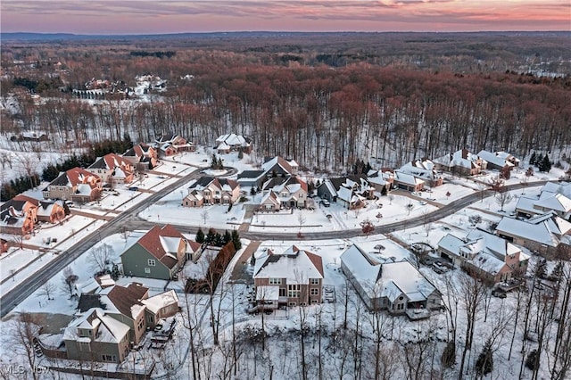 snowy aerial view with a residential view