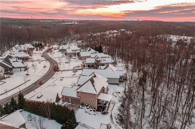 snowy aerial view featuring a residential view