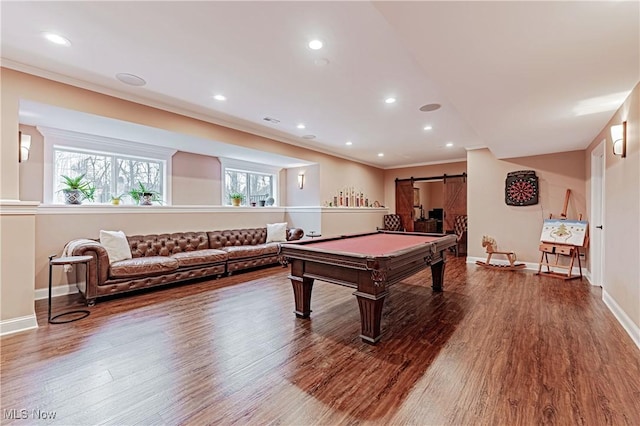 recreation room with a barn door, pool table, wood finished floors, baseboards, and ornamental molding