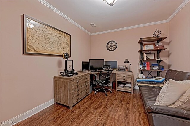 office area featuring visible vents, crown molding, baseboards, and wood finished floors