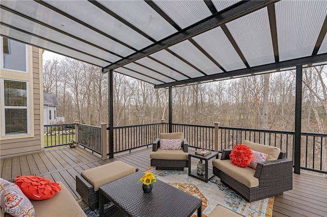 wooden terrace with an outdoor living space