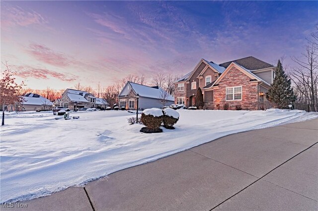 yard layered in snow featuring a residential view