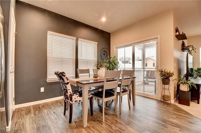 dining room featuring light wood finished floors and baseboards