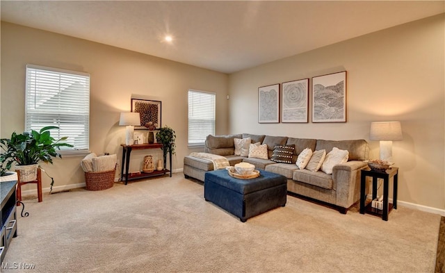 carpeted living room with baseboards