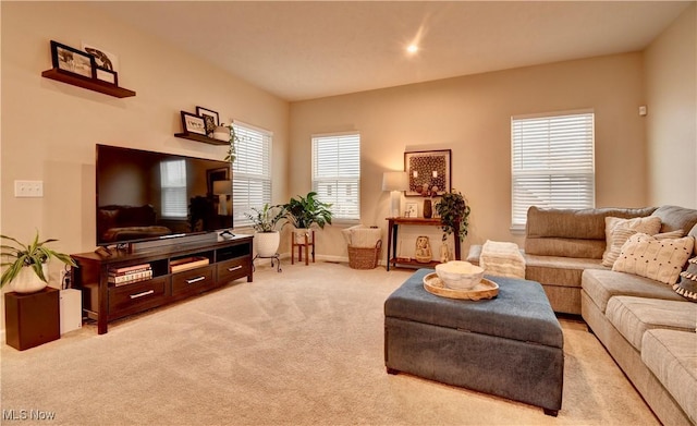 living room featuring baseboards and light carpet